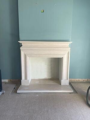 White limestone surround fitted with white granite hearth